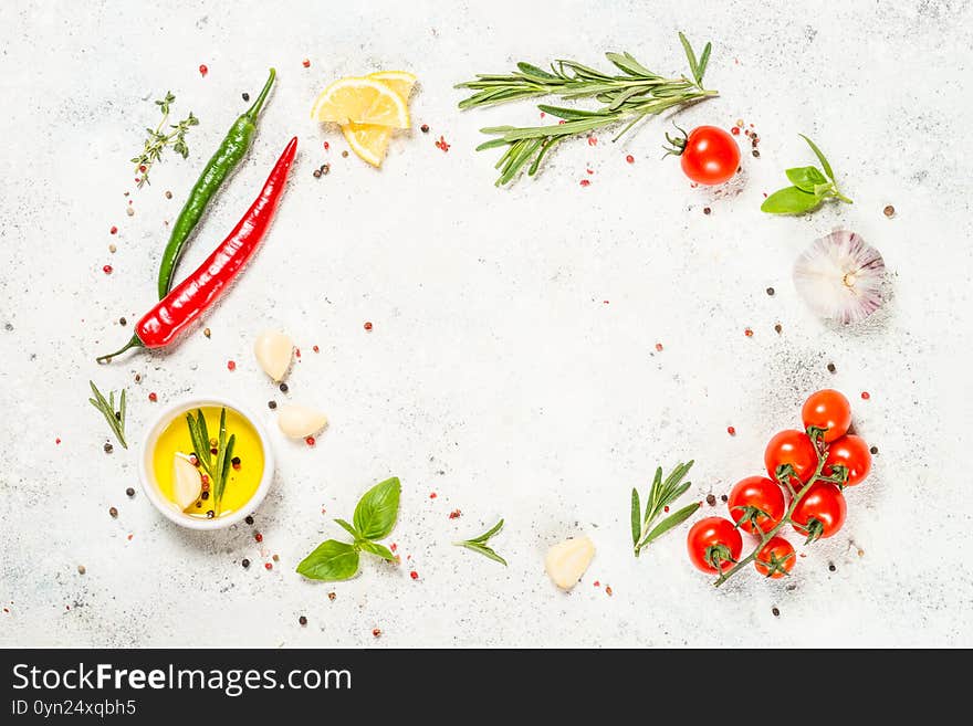 Food frame. Food cooking background. Herbs, spices and vegetables at white kitchen table. Top view, mock up.