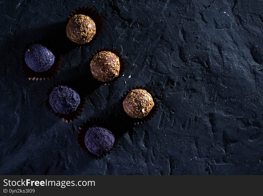 Colored round candies on a dark background