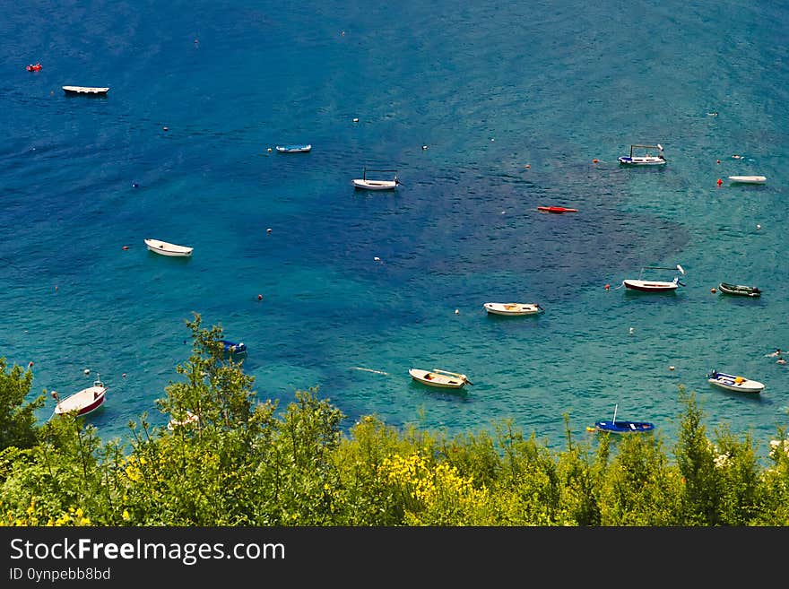 Blue bay with boats and trees on a foreground. Blue bay with boats and trees on a foreground