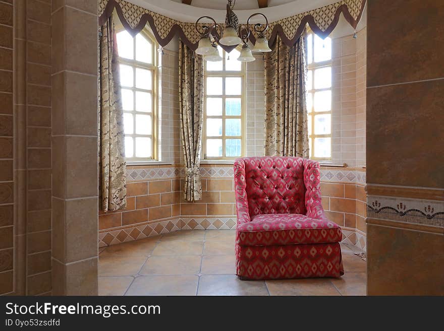 Red cloth sofa in castle tower old building interior