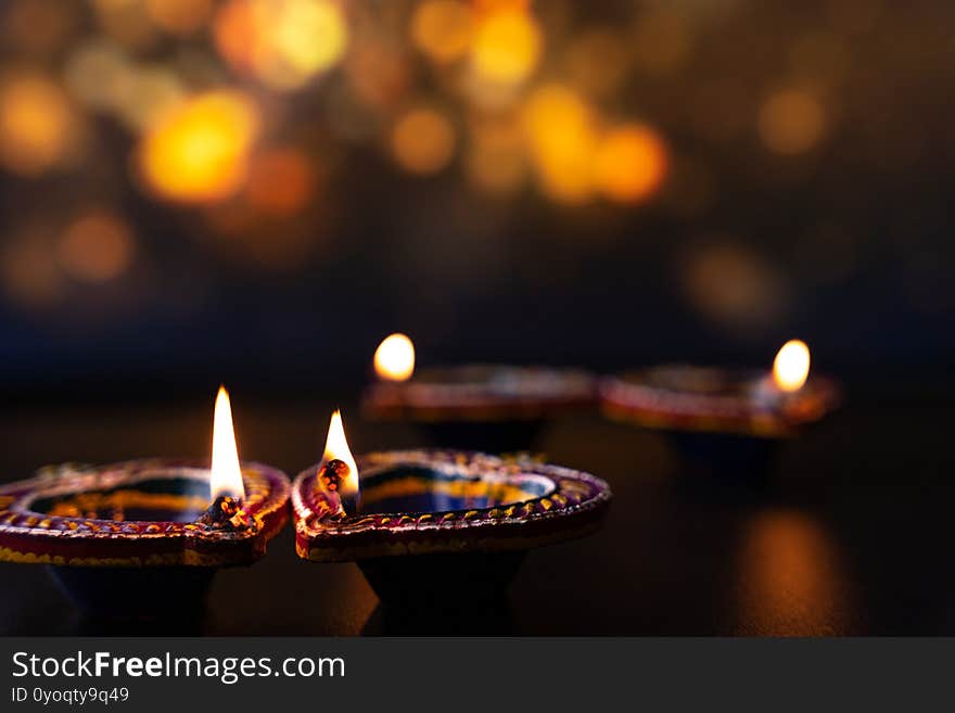 Indian festival Diwali, Diya oil lamps lit on colorful rangoli. Hindu traditional. Happy Deepavali. Copy space for text.