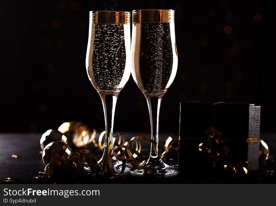 Selective Focus Of Glasses Full Of Champagne Against Christmas Lights