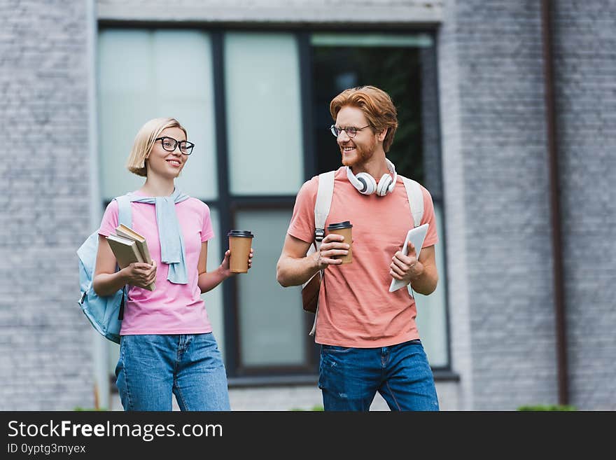 Holding Paper Cups, Books And Digital