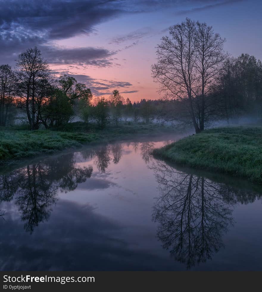 May sunrise and a small river with fog in the very early morning