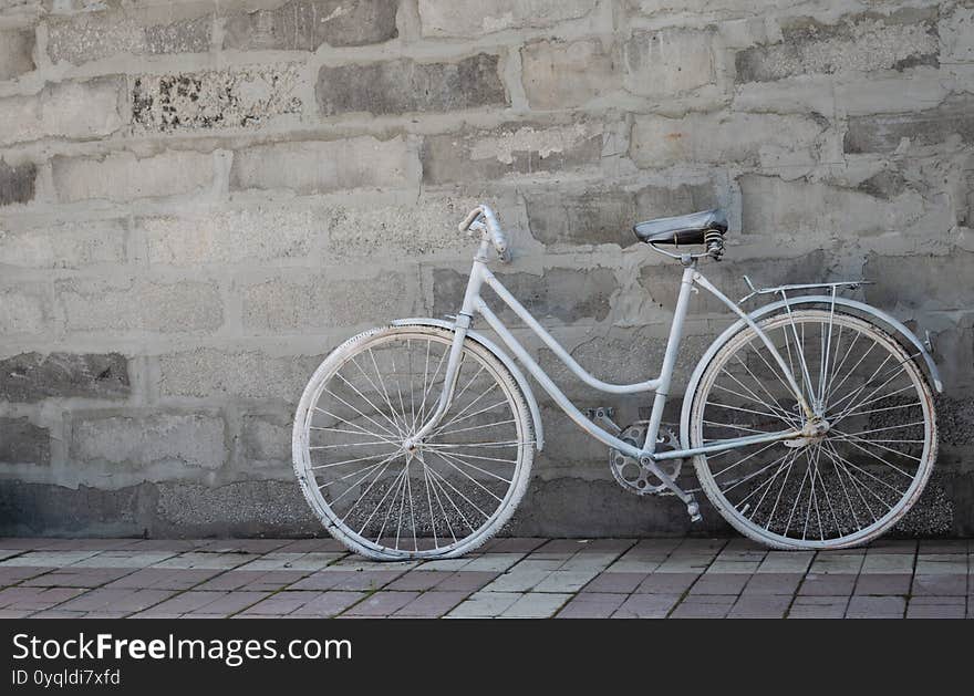 White bike on concrete wall background