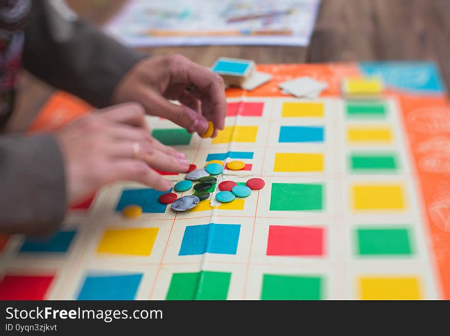 Process of playing retro vintage old style board game and having fun with friends and family, board game concept, hand playing and roll the dice outdoor