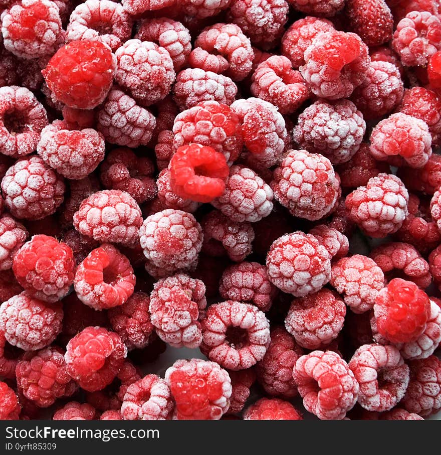 Fresh frozen raspberry background close up photo. Red, ripe raspberries. Berry background. Red background. Healthy diet. Good nutrition. The summer harvest. The frost on the berries.