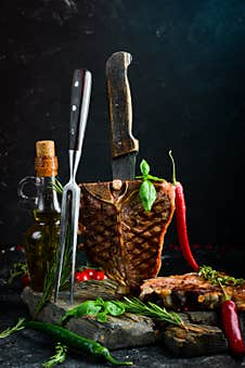 Juicy Grilled Steak From Angus With Spices And Herbs On A Black Background. Bull Angus. Top View. Rustic Style Royalty Free Stock Photography