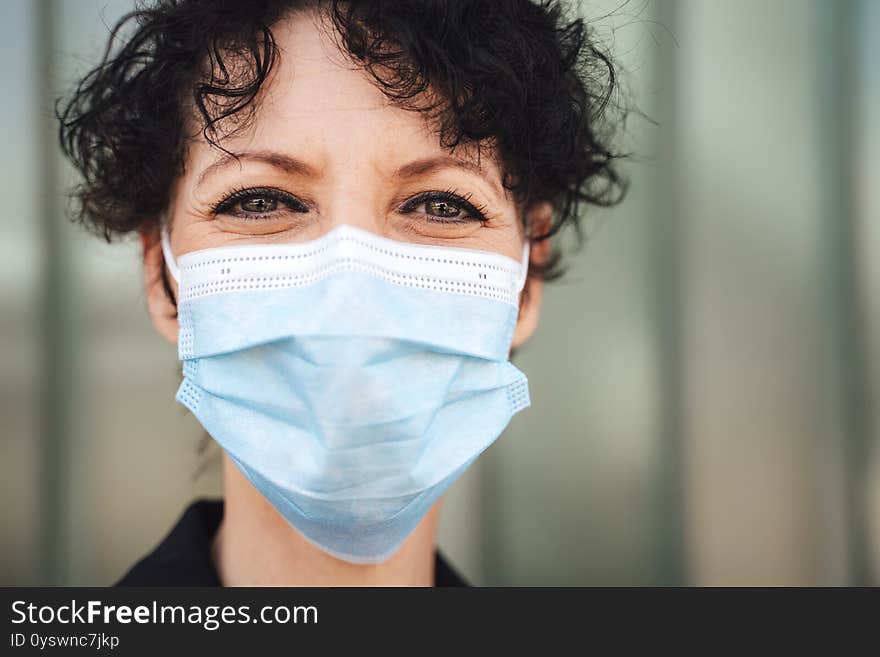 Close up portrait of Caucasian mature woman wearing face mask during COVID-19 outbreak