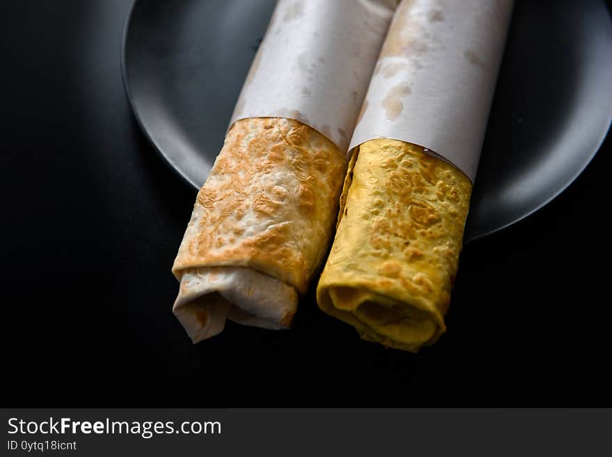 Flour tortilla with filling on a platter.