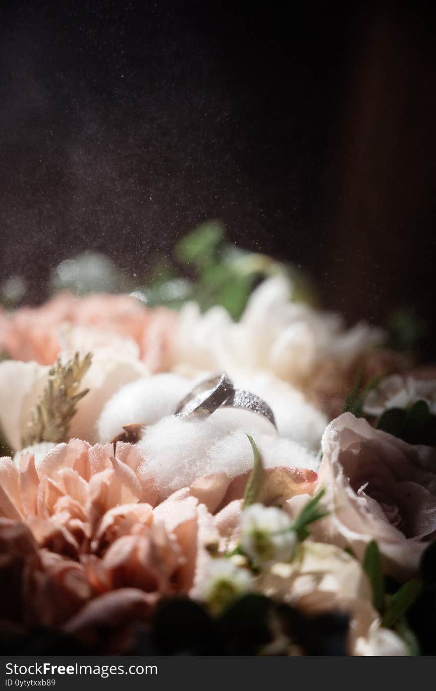 Wedding rings lie on a flower close up