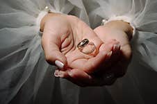 Two Wedding Rings In The Hands Of The Newlyweds Close Up Stock Image