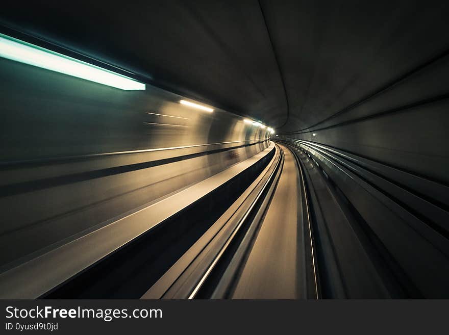 Long exposure shot of an empty tunnel with white lights