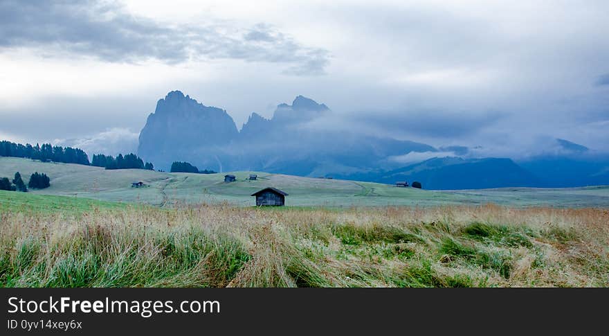 Cottages At The Foothills Of The Alpe Di Siusi, Seiser Alm With Sassolungo And Langkofel Mountain Group, South Tyrol, Italy