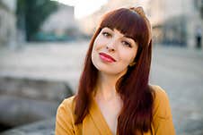 Close Up Face Portrait Of Young Smiling Charming Caucasian Woman Wearing Yellow Clothes, Posing To Camera Outdoors Stock Photography