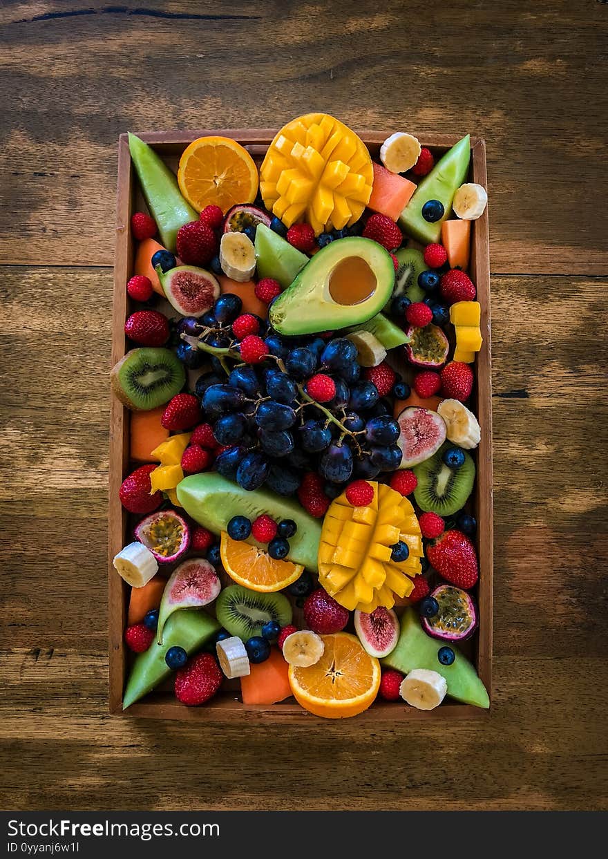 Mixed fresh fruits on rustic wooden tray background top view. Copy space. Mixed fresh fruits on rustic wooden tray background top view. Copy space.