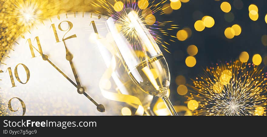 New year eve celebration with champagne flutes and midnight countdown  on golden firework bokeh background. Christmas party with