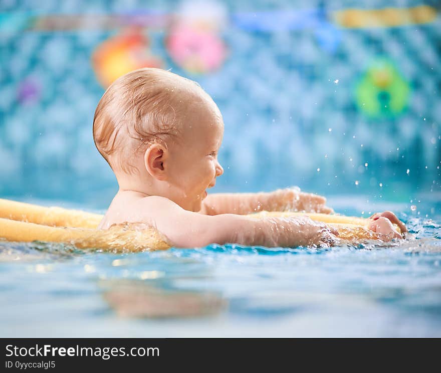 Baby having fun in the swimming pool