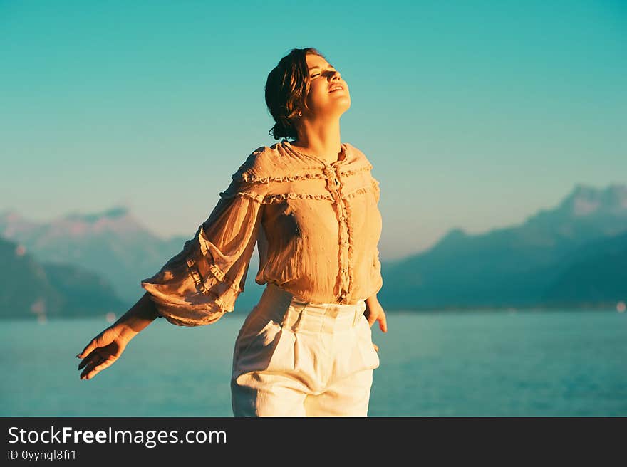 Romantic portrait of pretty young woman posing by the lake. Romantic portrait of pretty young woman posing by the lake