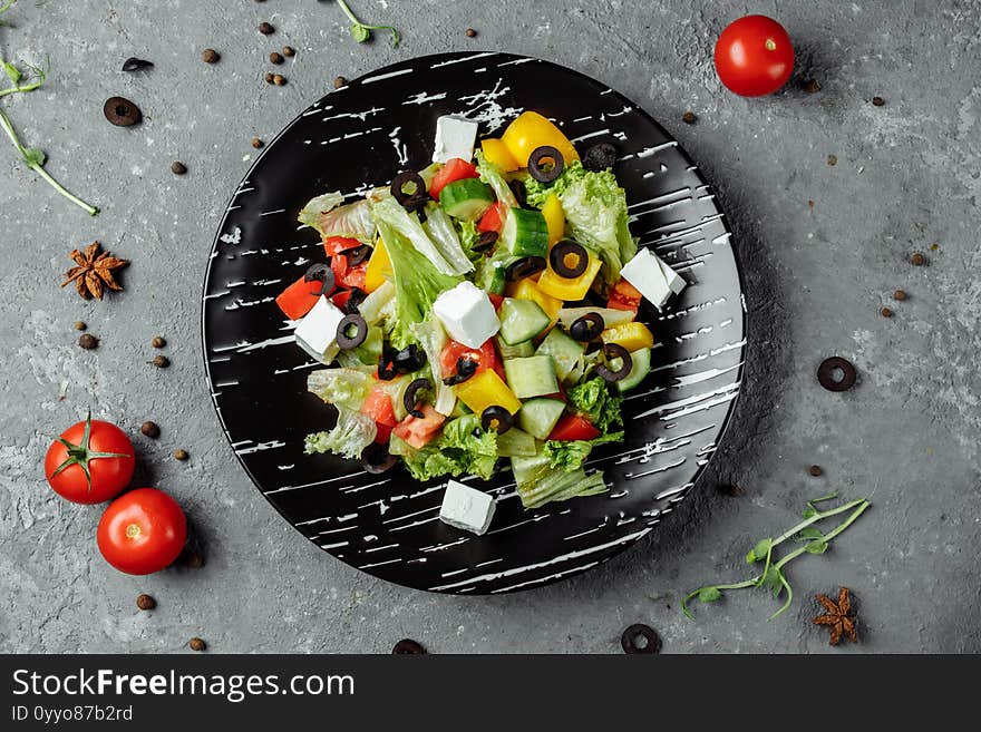 Greek Salad with Cucumeber, Kalamata Olives, Feta Cheese, Juicy Cherry Tomatoes and Fresh Basil. Concept for a tasty and healthy