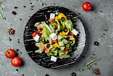 Greek Salad With Cucumeber, Kalamata Olives, Feta Cheese, Juicy Cherry Tomatoes And Fresh Basil. Concept For A Tasty And Healthy Royalty Free Stock Photography