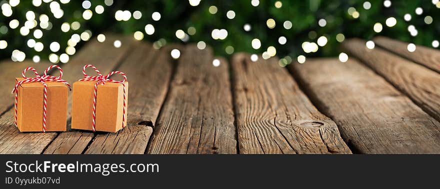 Christmas banner background,  gifts on old wooden table, bokeh lights