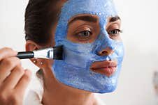 Woman Putting Mask On Her Face Royalty Free Stock Photo