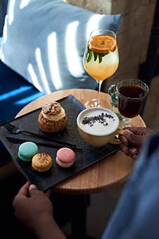 Waiter Serves Coffee And Cakes To The Client Royalty Free Stock Photo