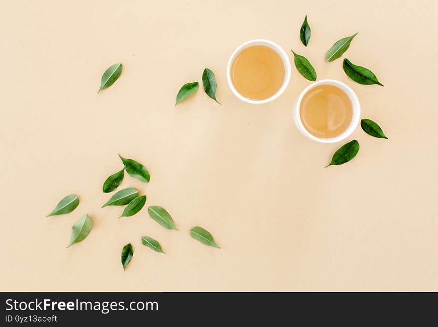 Cup of fresh green tea with tea leaves. Flat lay, top view. Tea concept