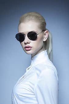 Frontal Portrait Of A Blonde Female Model With Makeup And Ponytail Hairstyle, Wearing White Shirt Looking At Camera. Stock Photography