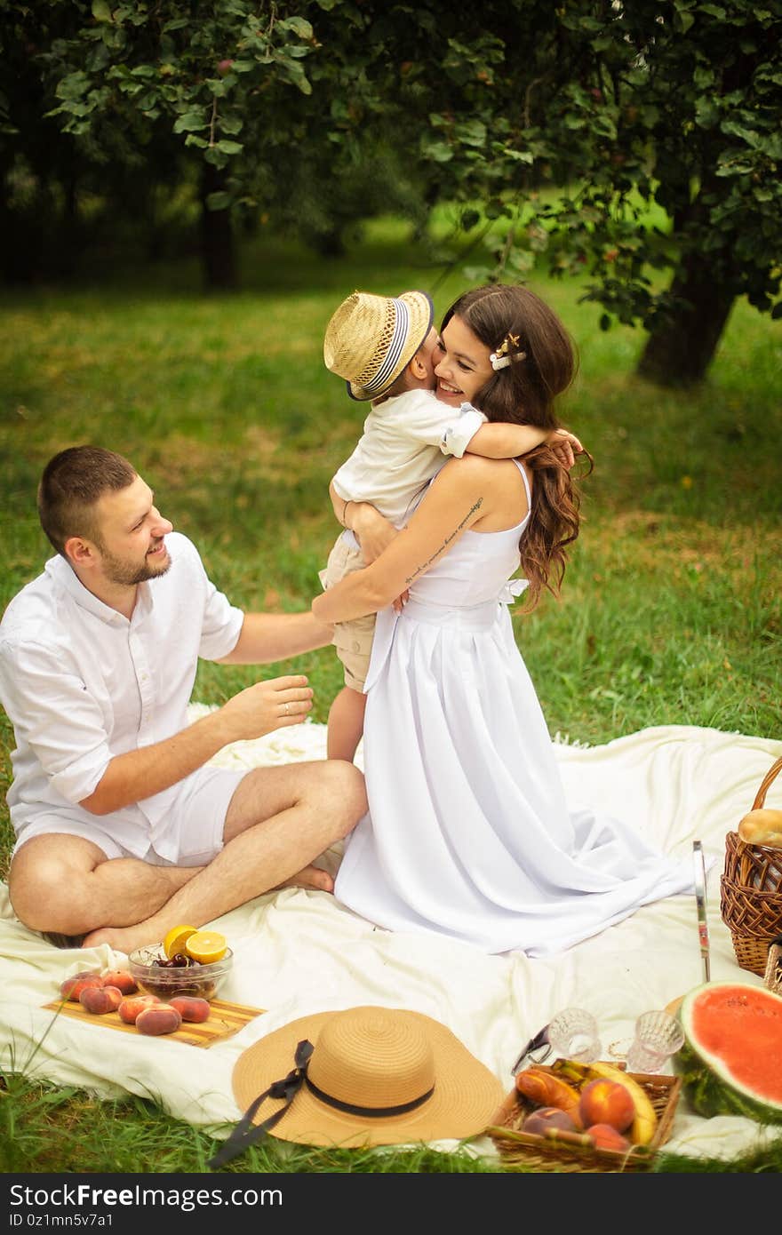 Loving Parents With Their Son At Picnic.