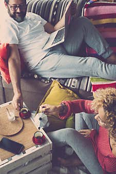 Adult Happy Couple At Home In Autumn Season And Coloured Decorations Around - Real Life Scene With Caucasian People In Breakfast Stock Photo