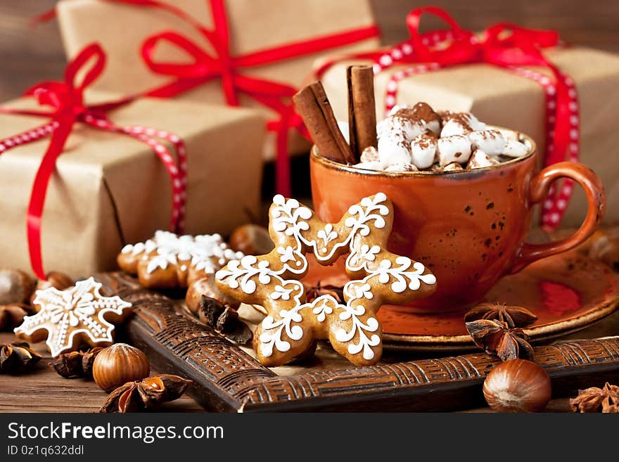 Ceramic mug with hot chocolate, marshmallows and  gingerbread cookies on   wooden   background  for christmas holiday. Ceramic mug with hot chocolate, marshmallows and  gingerbread cookies on   wooden   background  for christmas holiday