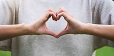 A Woman Making Heart Hand Sign Stock Photography