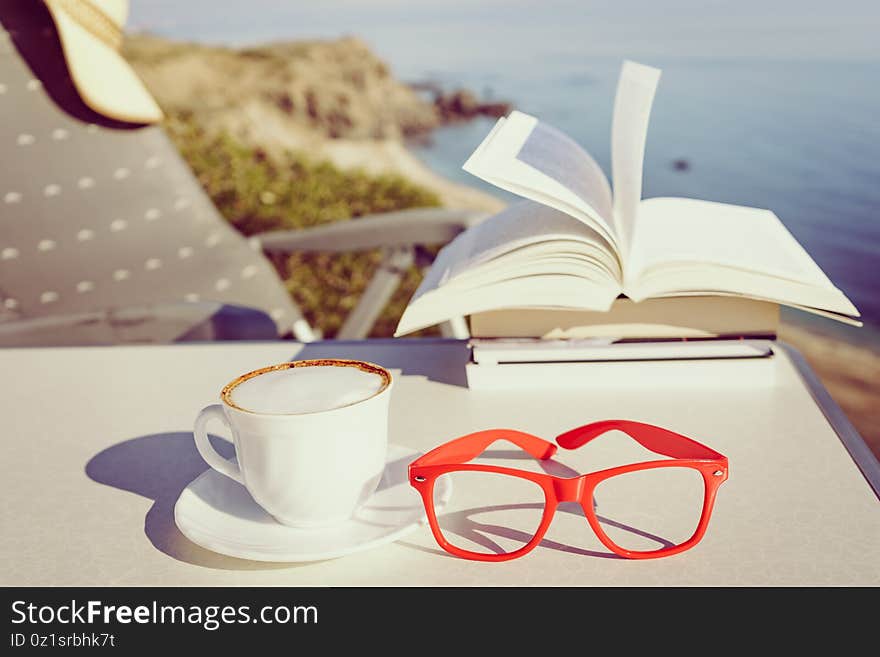 Coffee cup and books outdoors