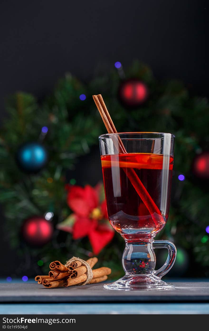 Mulled wine in glass mug. Hot red wine with fruits and spices. Traditional hot drink in Christmas time. Festive decoration.Winter holiday mood concept.