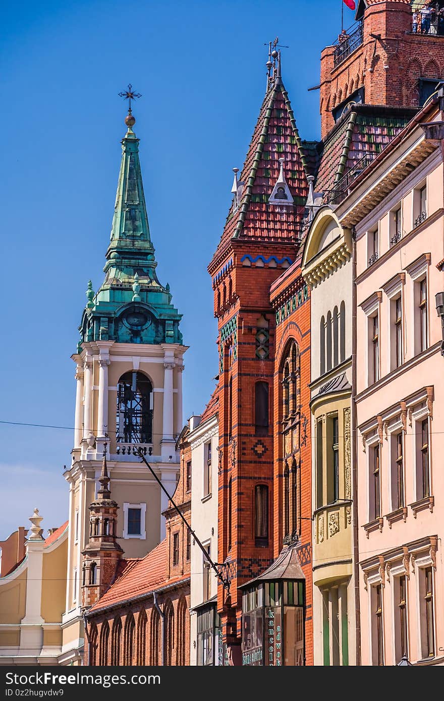 Church Of The Holy Spirit Surrounded By Buildings Under The Sunlight And A Blue Sky In Torun, Poland