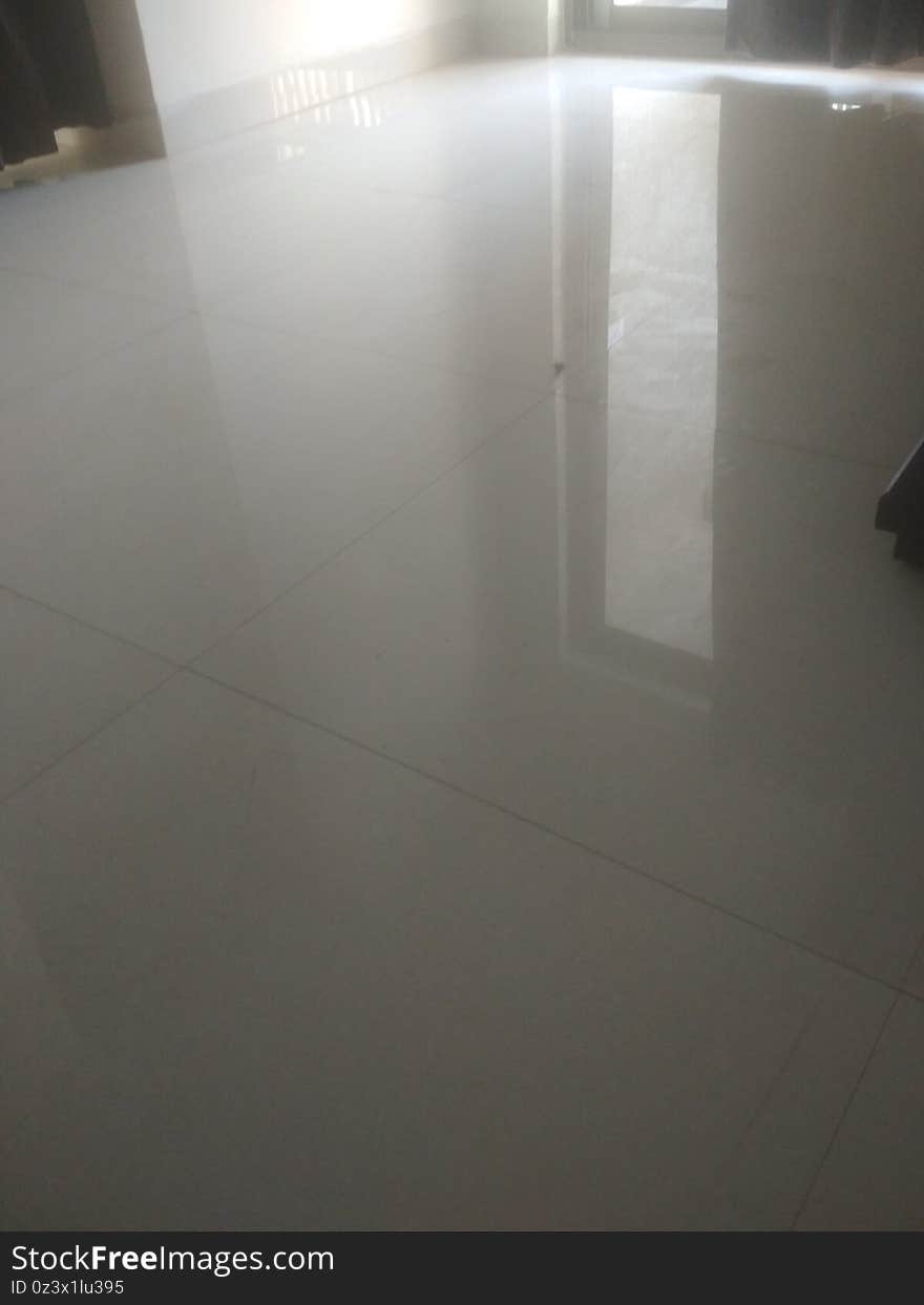 White tiles royal floor surface in a apartment in India