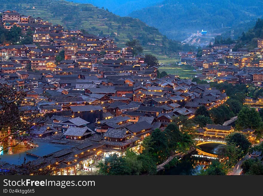 Beautiful night view of the stilted building in the Qianhu Miao Village in Xijiang, Guizhou, China. Beautiful night view of the stilted building in the Qianhu Miao Village in Xijiang, Guizhou, China