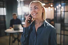 Smiling Young Businesswoman Talking On Her Cellphone At Work Royalty Free Stock Photography