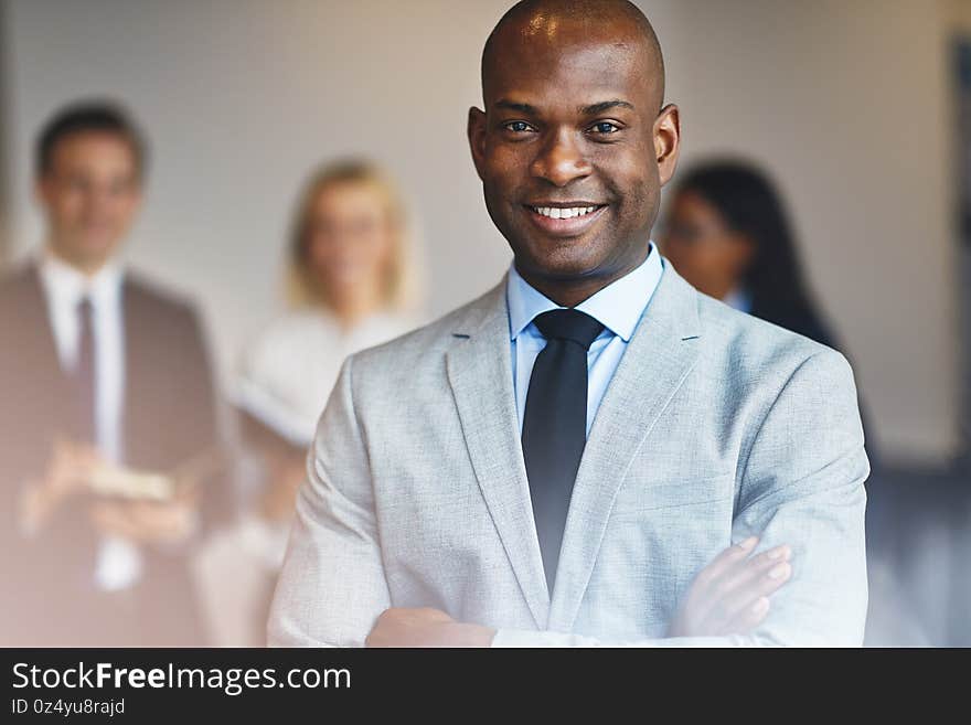 Young African businessman standing in an office