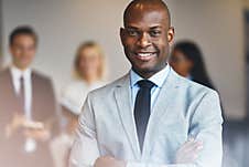 Young African Businessman Standing In An Office Royalty Free Stock Photos