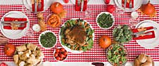 Shot Of Table With Salad, Glasses, Candles, Vegetables, Pepper Mill, Corn, Salt Mill And Pumpkins In Thanksgiving Day Royalty Free Stock Photography