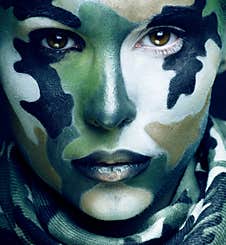 Beautiful Young Fashion Woman With Military Style Clothing And Face Paint Make-up, Khaki Colors, Halloween Celebration Royalty Free Stock Images