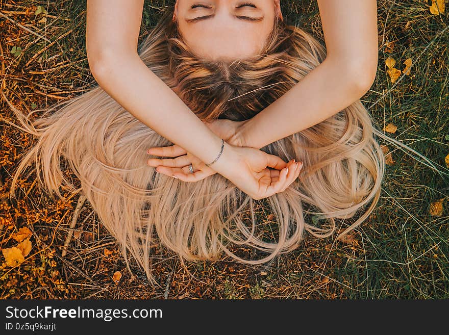 The girl`s hair spread across the grass