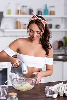 Selective Focus Of Housewife Using Mixer Royalty Free Stock Image