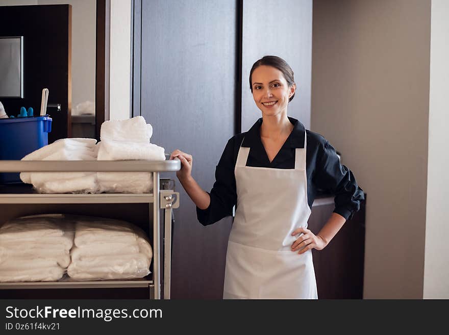 A member of a hotel service staff doing her job