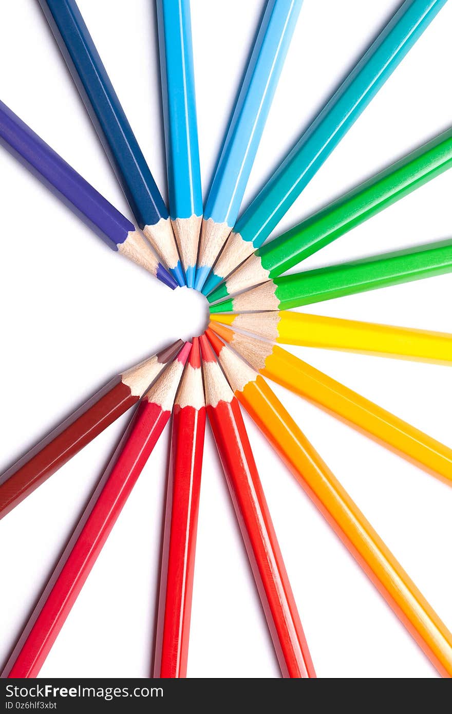 Circle or semicircle of colored sharp pencils spouts in the center on a white isolated background