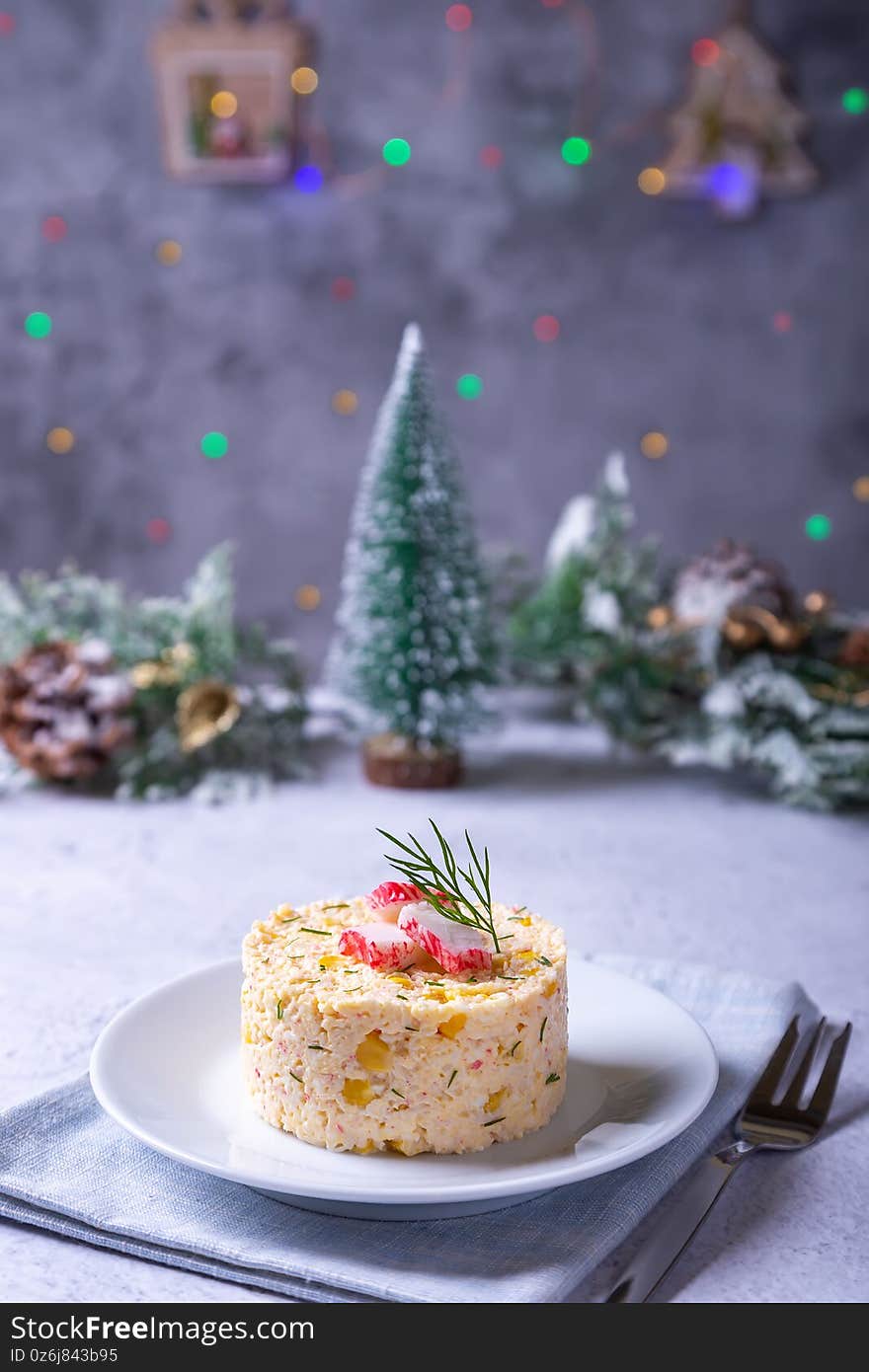 Crab Salad With Corn And Eggs On A White Plate. New Year`s And Christmas. Traditional Russian Salad.