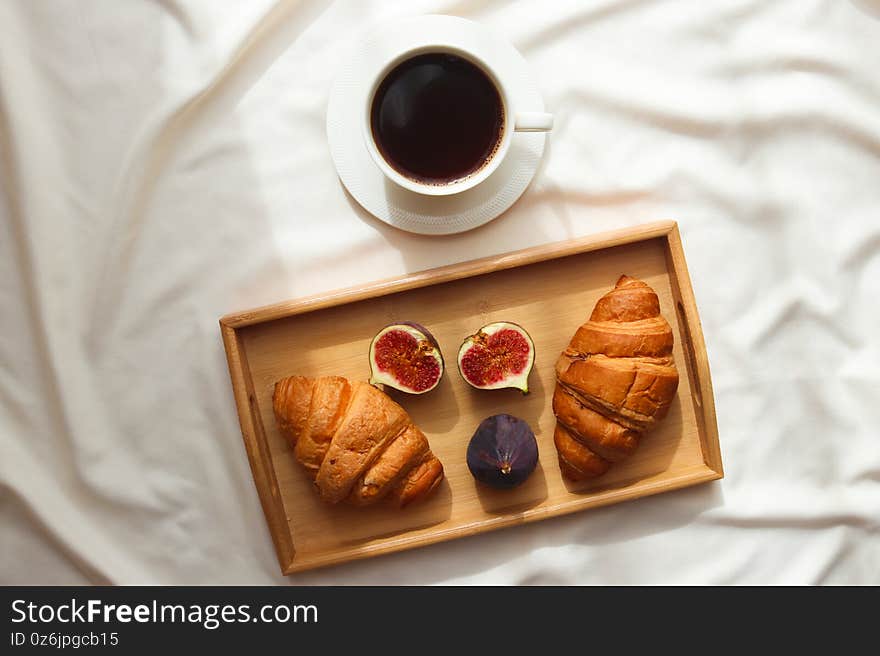 Morning Coffee In Bed. A Cup Of Coffee With Croissants And Figs On A Wooden Tray. Lifestyle, Morning Concept. Top View